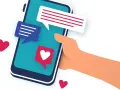 Main tenant une main un smartphone avec des bulles de discussion et des cœurs. L'image évoque le sentiment d'attente et d'espoir après le premier rendez vous.