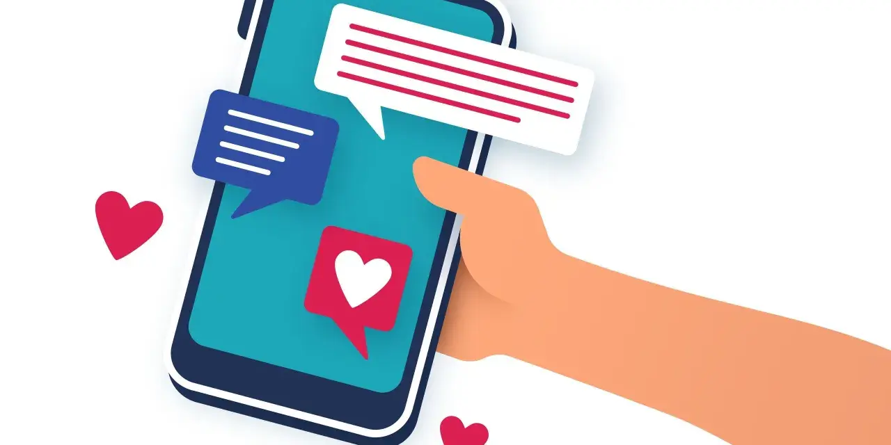 Main tenant une main un smartphone avec des bulles de discussion et des cœurs. L'image évoque le sentiment d'attente et d'espoir après le premier rendez vous.