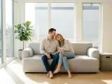 Couple complice sur un canapé, profitant d'un moment de tendresse. Le manque d'intimité dans le couple est ici absent, remplacé par une connexion palpable.