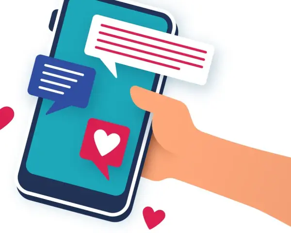 Main tenant une main un smartphone avec des bulles de discussion et des cœurs. L'image évoque le sentiment d'attente et d'espoir après le premier rendez vous.