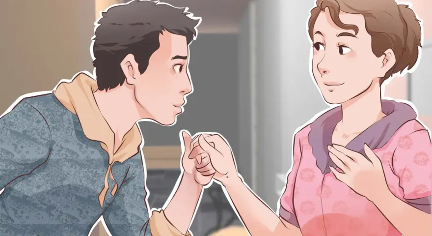 Un garçon tient la main d'une fille, un geste tendre pour lui montrer comment plaire à un garçon.