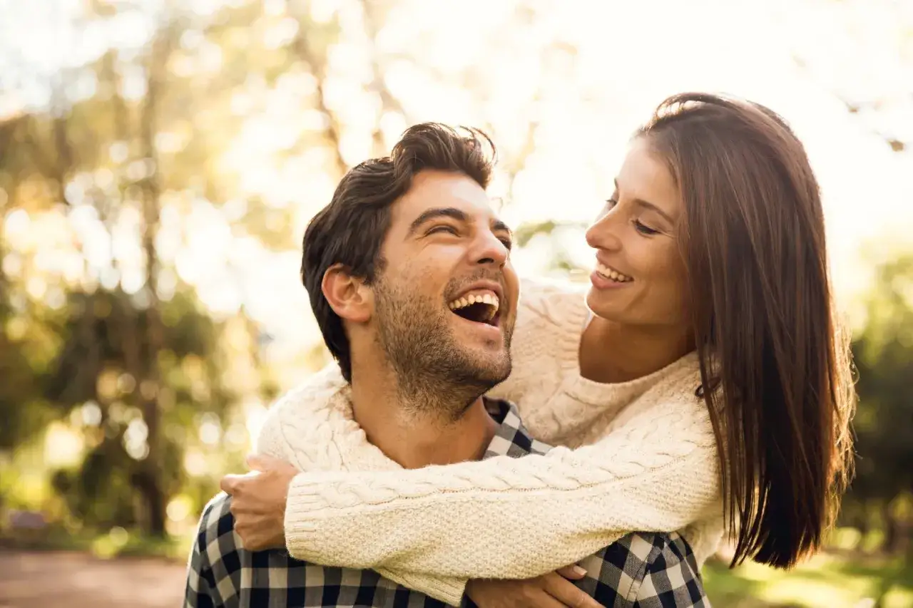 Un couple qui ne se voit que le week-end rit aux &eacute;clats, profitant de chaque instant vol&eacute; dans la nature.